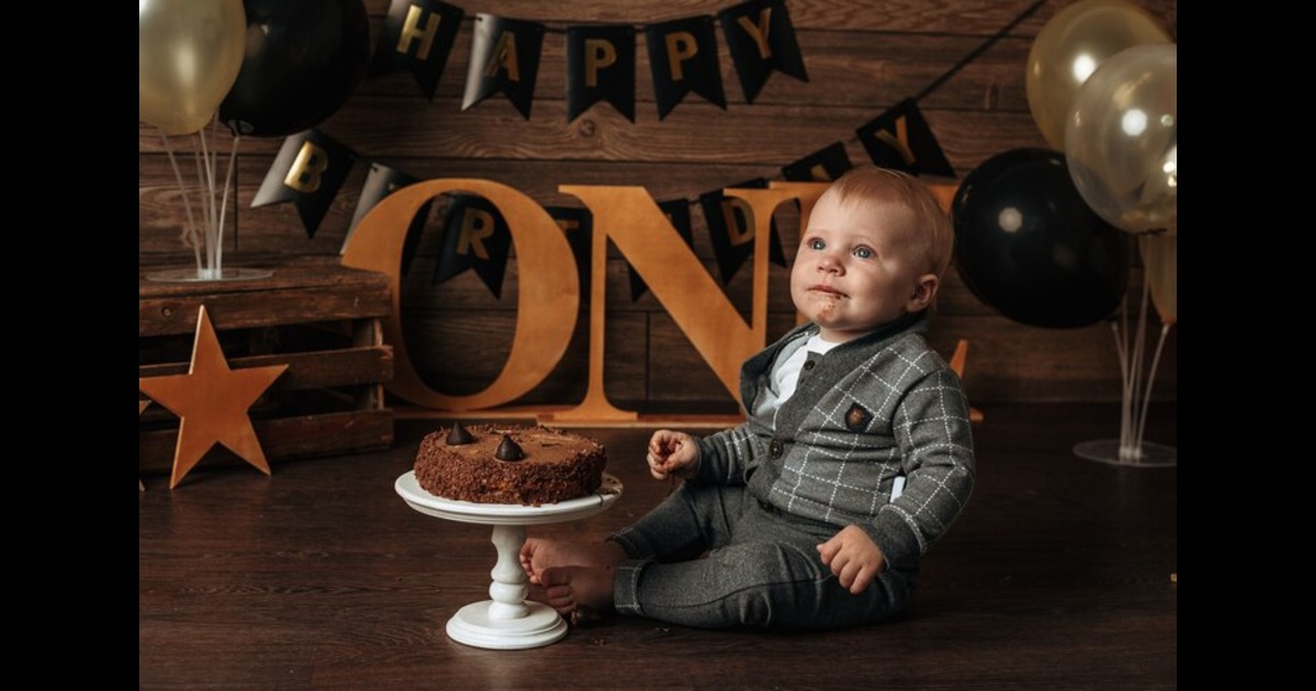 One year old baby boy sitting on floor for cake smash photography